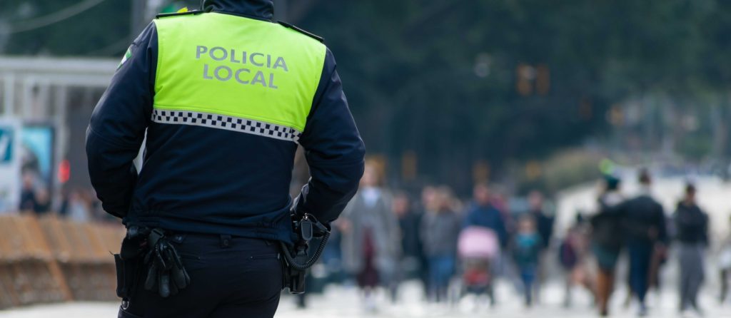Closeup Shot Of A Police Officer With "local Police" Written On The Uniform In Spanish